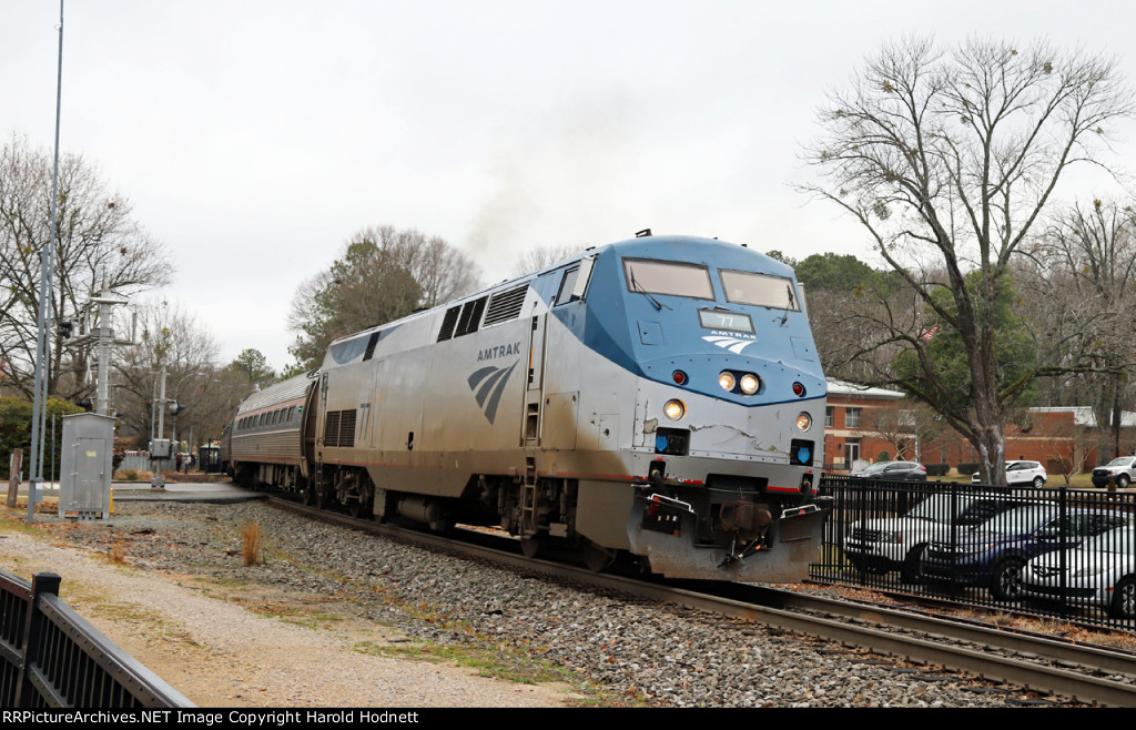 AMTK 77 leads train p080-26 away from the station